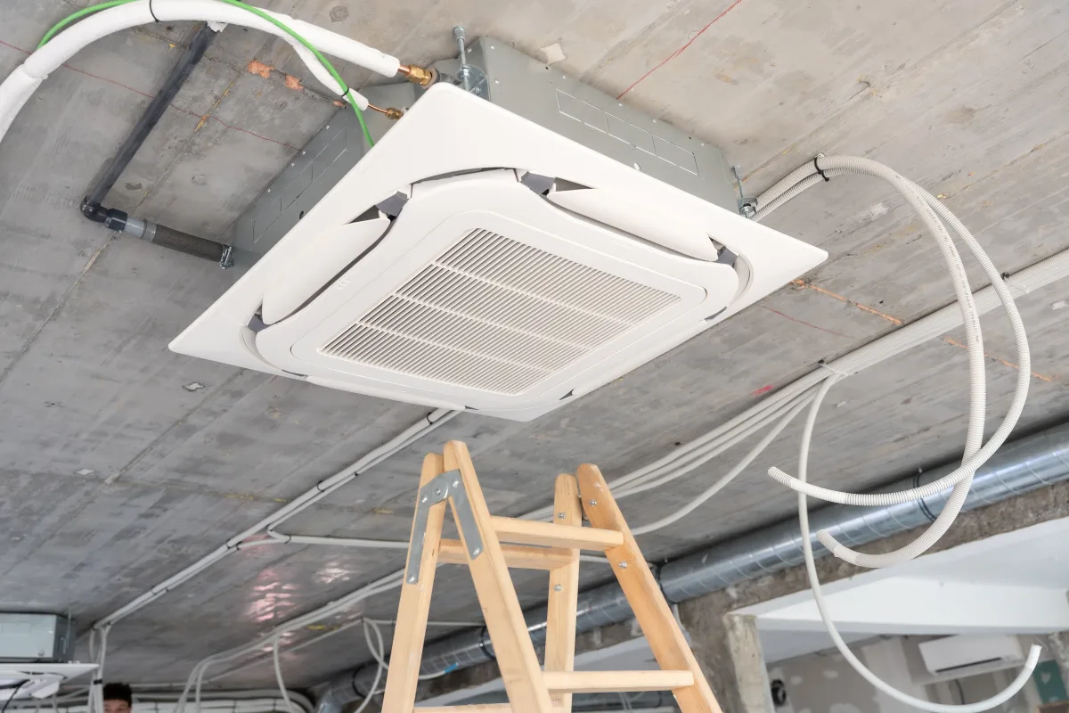 Ducted air conditioning cassette being installed in a ceiling