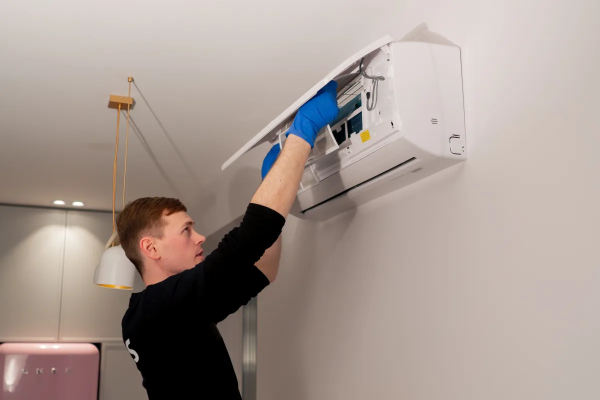 Technician servicing a split-system indoor unit